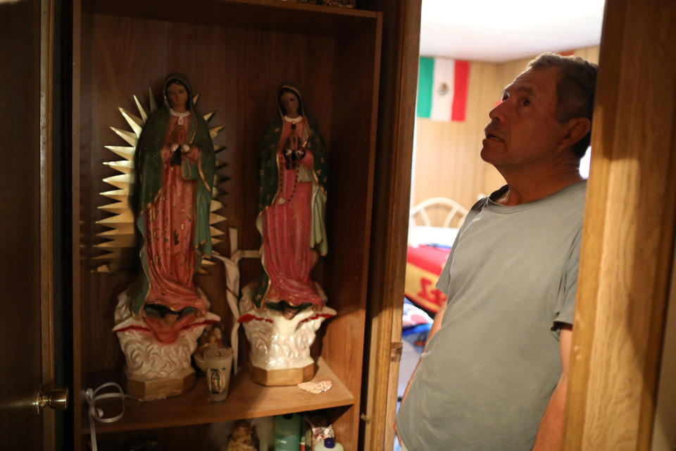 <p>Roberto Obispo, 65, stepfather of immigrant Rosa Sabido, stands next to a shrine in his home, which is next door to the home Rosa left to live in sanctuary in the United Methodist Church while facing deportation, in Cortez, Colo., July 19, 2017. (Photo: Lucy Nicholson/Reuters) </p>