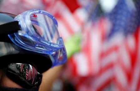 A protester is seen next to U.S. flags in Central, Hong Kong