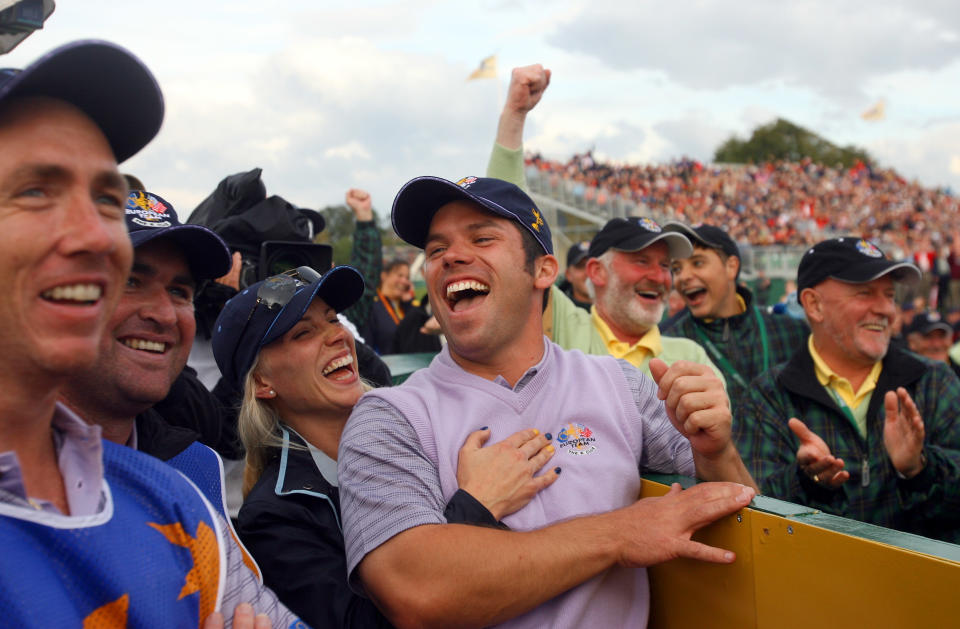 Europe’s Paul Casey, center, is embraced by his partner Jocelyn Hefner as they watch a replay of his hole-in-one on the 14th tee after the foursomes match against Stewart Cink and Zach Johnson of the United States, on the second day of the 2006 Ryder Cup at the K Club, Straffan, Ireland, Saturday Sept. 23, 2006.