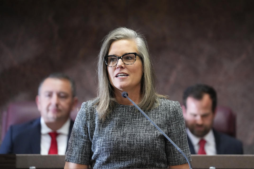 Arizona Democratic Gov. Katie Hobbs, middle, speaks as she gives the state of the state address, flanked by Arizona House Speaker Ben Toma, R-Glendale, left, and Arizona Senate President Warren Petersen, R-Gilbert, right, at the Arizona Capitol in Phoenix, Monday, Jan. 9, 2023. (AP Photo/Ross D. Franklin)