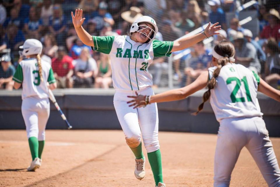 Dixon Rams baserunner Ashley Garcia (28) celebrates being hit in to score on a double by batter Camryn Elliot (26) during the sixth inning against the Capital Christian Cougars at the CIF Sac-Joaquin Section Division IV high school softball championship game Saturday, May 27, 2023, at Cosumnes River College.