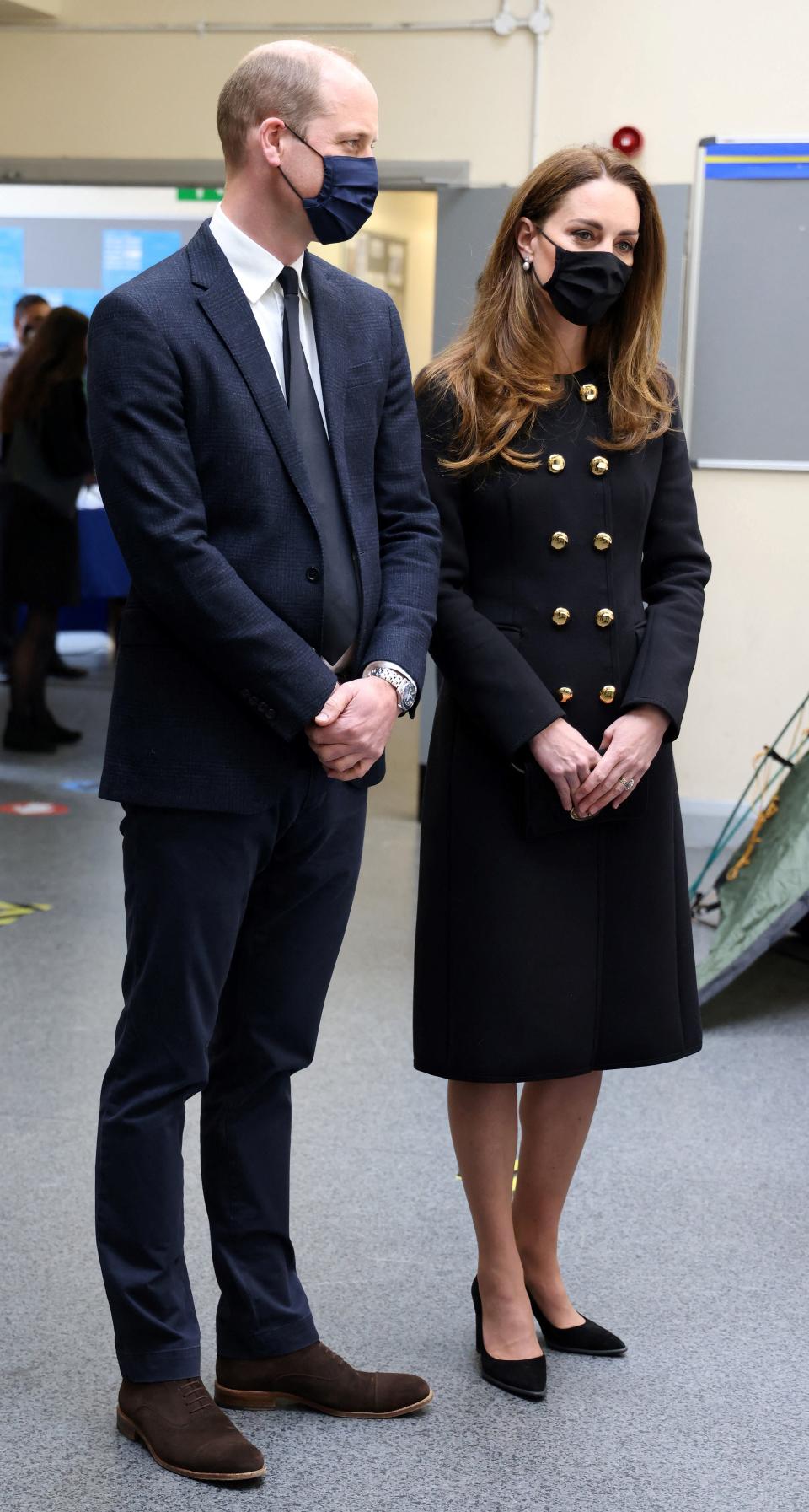 Britain's Prince William, Duke of Cambridge, and Britain's Catherine, Duchess of Cambridge, wearing black as a mark of respect following the death of Britain's Prince Philip, Duke of Edinburgh, and a face covering to combat the spread of Covid-19, talk with Air Cadets during their visit to 282 (East Ham) Squadron Air Training Corps in east London on April 21, 2021. - During the visit, the Squadron paid tribute to The Duke of Edinburgh, who served as Air Commodore-in-Chief of the Air Training Corps for 63 years. In 2015, The Duke passed the military patronage to The Duchess of Cambridge who became Honorary Air Commandant. (Photo by Ian Vogler / POOL / AFP) (Photo by IAN VOGLER/POOL/AFP via Getty Images)