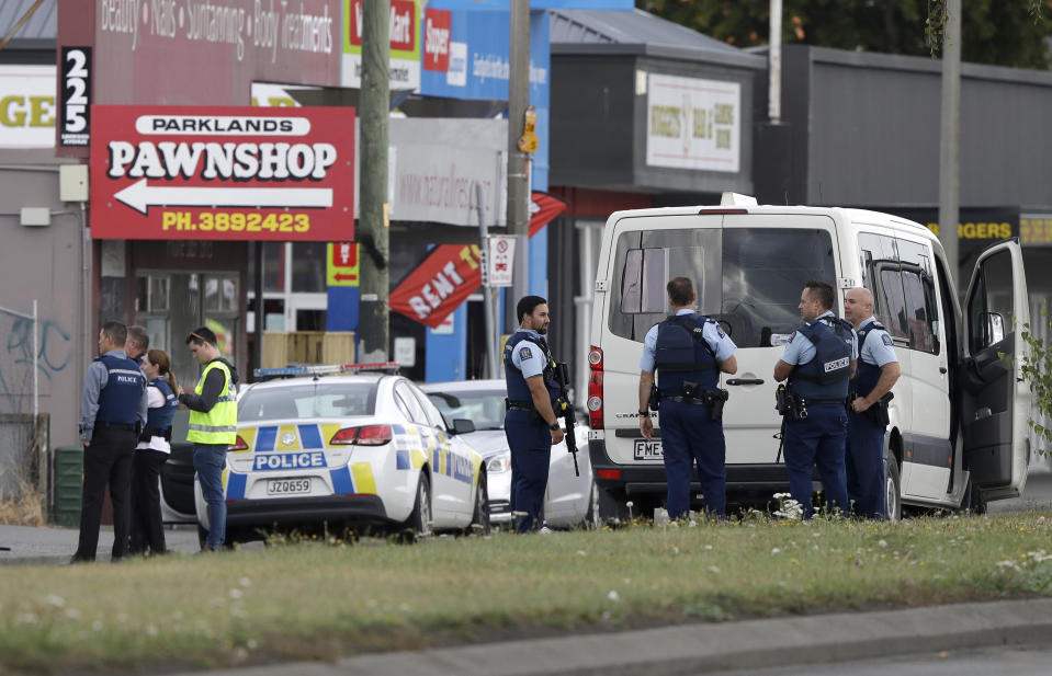 FILE - In this March 15, 2019, file photo, police stand outside a mosque in Linwood, Christchurch, New Zealand. New Zealand police on Wednesday, April 17, 2019 released a detailed timeline of their response to the March 15 shootings that left 50 dead at two Christchurch mosques, confirming they arrested the suspected shooter 18 minutes after receiving the first emergency call. (AP Photo/Mark Baker, File)