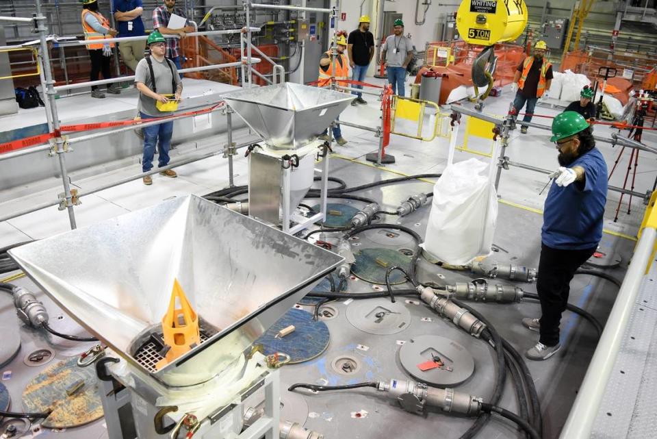 Workers at the Hanford site vitrification plant added the first frit, or glass beads, to the melter inside the Low-Activity Waste Facility last week as preparations are made to glassify radioactive waste.