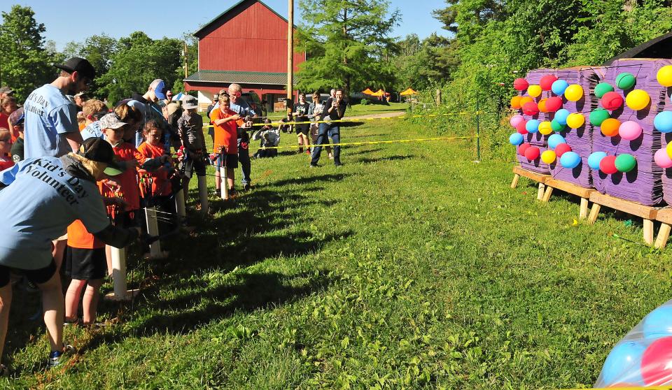 Kids try their hand at archery during Kids Outdoor Day at the Ashland County Wildlife Conservation League Farm Saturday, June 4, 2022, hosted by the ACWCL and Fin Feather Fur Outfitters.  LIZ A. HOSFELD/FOR TIMES-GAZETTE.COM