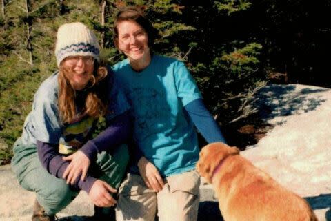 Lollie Winans and Julie Williams pose with their dog, Taj, who was found unharmed on a park trail after their killings. 