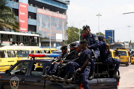 Congolese policemen drive past Congo's Independent National Electoral Commission (CENI) headquarters in Kinshasa, Democratic Republic of Congo, January 9, 2019. REUTERS/Baz Ratner