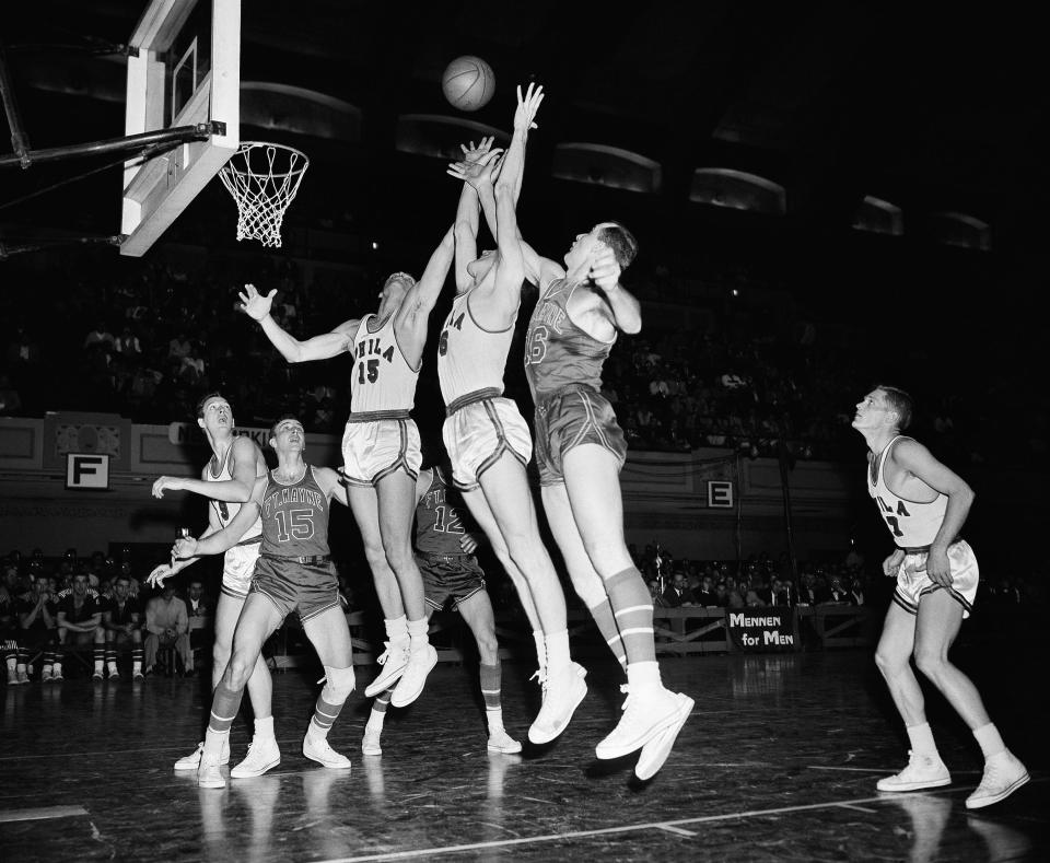 Neil Johnston (6) of the Philadelphia Warriors reaches for a rebound in a game against the Fort Wayne Pistons on March 31, 1956. Also going for the ball are Warrior Tom Gola (15) and Piston Larry Foust (16). Also pictured are (from left): Joe Grabowski (9), of the Warriors; and Jesse Arnell (15) and George Yardley (12) of the Pistons.