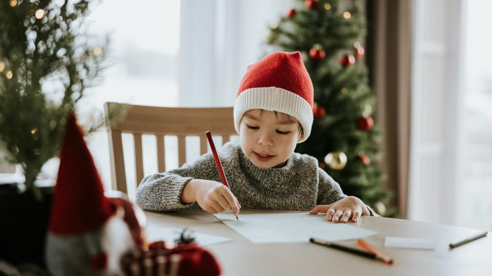 boy writes a letter to santa clause