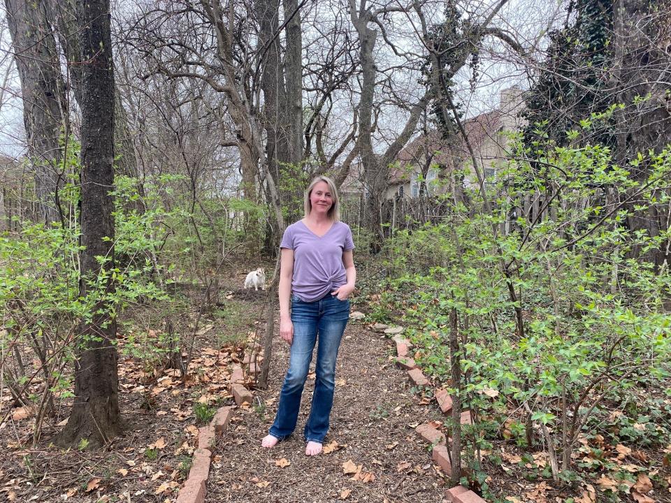 In this March 30, 2020 photo, Hollie Niblett is stands in her garden at her home in Overland Park, Kan. Amid the coronavirus outbreak, backyard gardens are turning into a getaway for the mind in chaotic times. (Maya Niblett via AP)