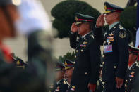 Thailand's outgoing Royal Army Chief, General Chalermchai Sittisart (centre L) stands with General Apirat Kongsompong as they review honor guards during their handover ceremony for the new Royal Thai Army Chief at the Thai Army headquarters in Bangkok, Thailand, September 28, 2018. REUTERS/Athit Perawongmetha