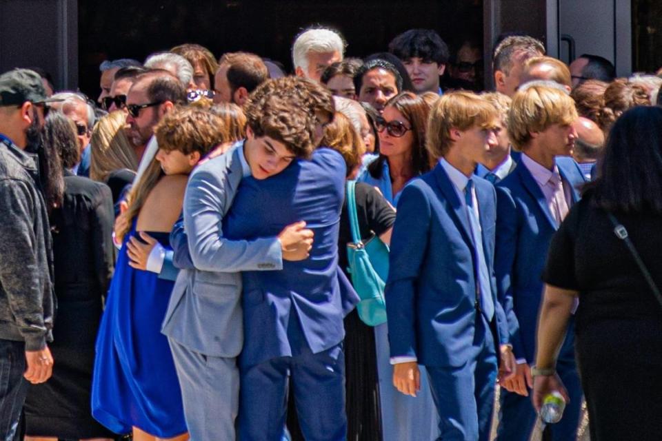 People hug each other after Lucy Fernandez’s funeral Mass at the Church of the Epiphany near South Miami on Monday, Sept. 12, 2022.