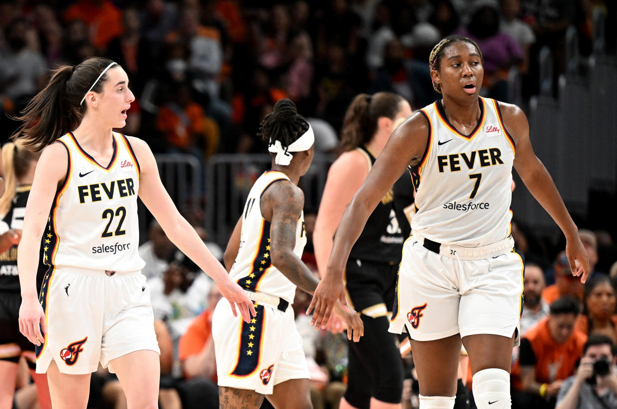 WASHINGTON, DC - JUNE 07: Caitlin Clark #22 and Aliyah Boston #7 of the Indiana Fever celebrate during the game against the Washington Mystics at Capital One Arena on June 07, 2024 in Washington, DC. NOTE TO USER: User expressly acknowledges and agrees that, by downloading and or using this photograph, User is consenting to the terms and conditions of the Getty Images License Agreement. (Photo by G Fiume/Getty Images)