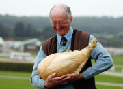 HARROGATE, ENGLAND - SEPTEMBER 16: Gardener Peter Glazebrook poses for photographers with his world record breaking onion at The Harrogate Autumn Flower Show on September 16, 2011 in Harrogate, England. Peter Glazebrook from Newark, Nottinghamshire claimed a Guinness World Record with his giant onion weighing 8.150kg. (Photo by Christopher Furlong/Getty Images)