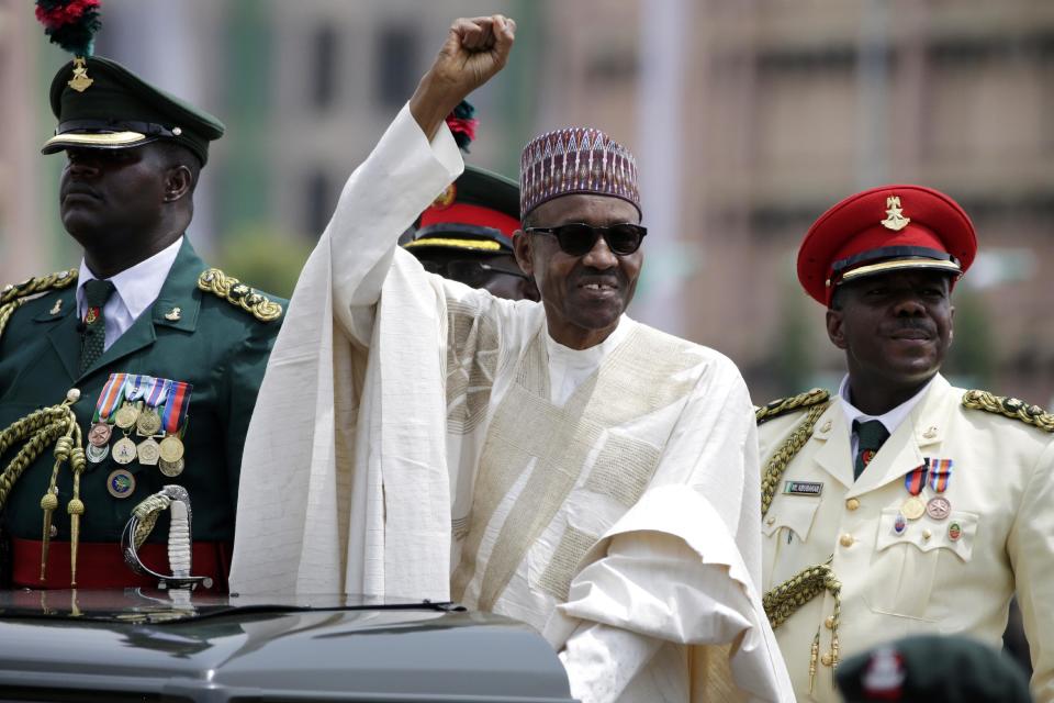 FILE - In this May 29, 2015, file photo, Nigerian President Muhammadu Buhari salutes his supporters during his inauguration in Abuja, Nigeria. Buhari is leading a regional delegation to Gambia in a last-ditch attempt to persuade its longtime leader to step down and allow his rival's inauguration next week. Buhari has been authorized to offer Gambian President Yahya Jammeh asylum, if necessary, during Friday, Jan. 13, 2017, visit. (AP Photo/Sunday Alamba, File)