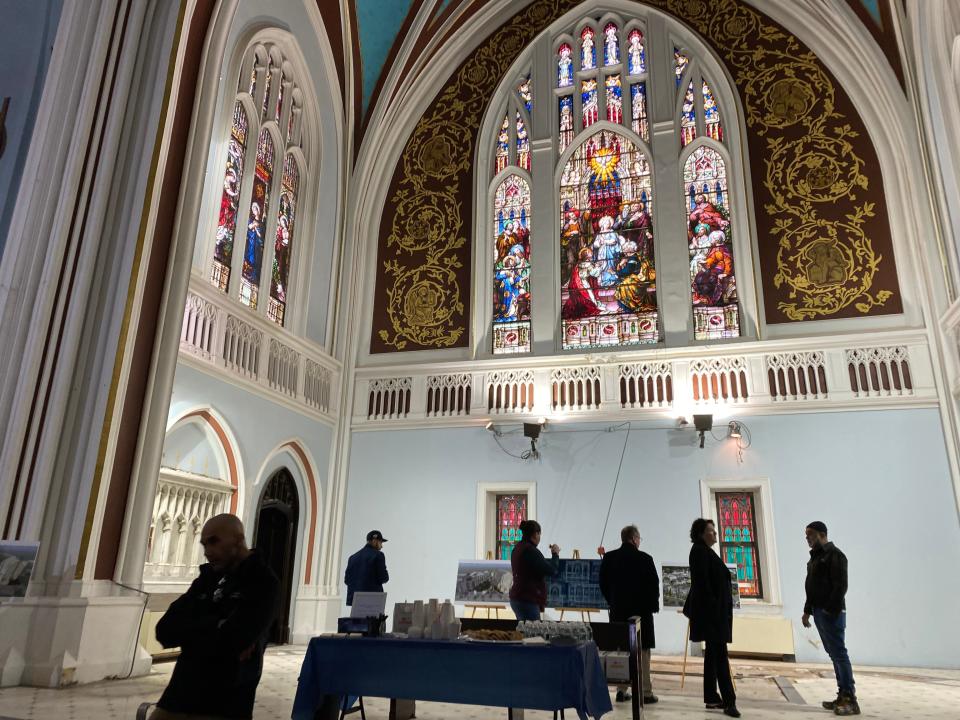 Residents and former parishioners gathered where the altar once stood looking at the displays from JLD Investment Group during the open house at Holy Spirit Church in Asbury Park on Feb. 19, 2023.