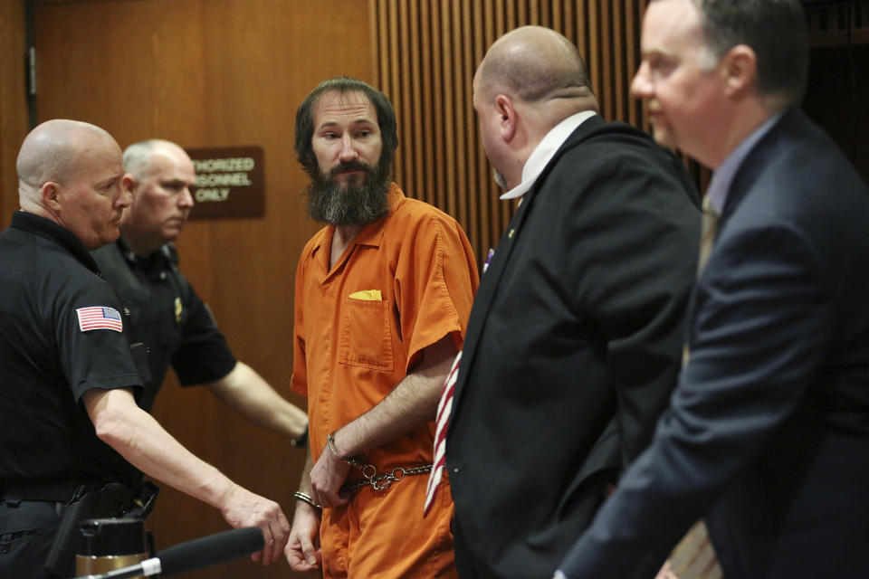 Johnny Bobbitt, center, is led away from his attorneys, John Keesler, second from right, and Stephen P. Hunter, following his sentencing hearing at Burlington County Superior Court in Mount Holly, N.J., Friday, April 12, 2019. Bobbitt, the homeless veteran who admitted to conspiring with a New Jersey couple in a GoFundMe scam that raised more than $400,000, was sentenced Friday to five years' probation. (Tim Tai/The Philadelphia Inquirer via AP, Pool)