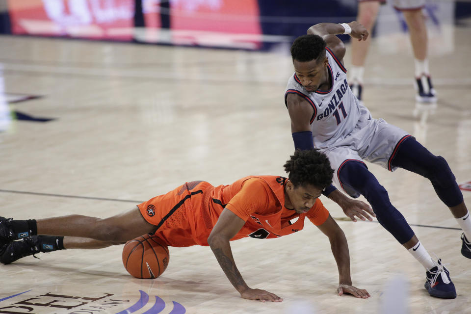 Pacific guard Daniss Jenkins, left, and Gonzaga guard Joel Ayayi go after the ball during the second half of an NCAA college basketball game in Spokane, Wash., Saturday, Jan. 23, 2021. (AP Photo/Young Kwak)