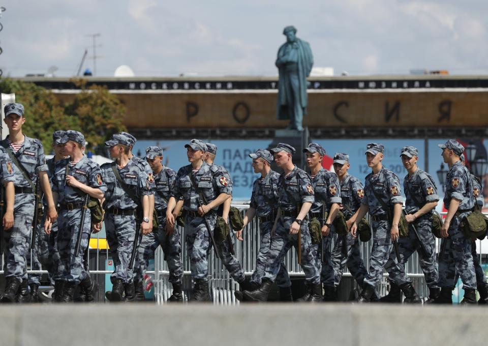 Russian policemen prepare to block a street prior to an unsanctioned rally in the center of Moscow, Russia, Saturday, July 27, 2019. Police have established a heavy presence at the Moscow mayor's office ahead of an expected protest rally and several opposition figures have been detained. (Pavel Golovkin)