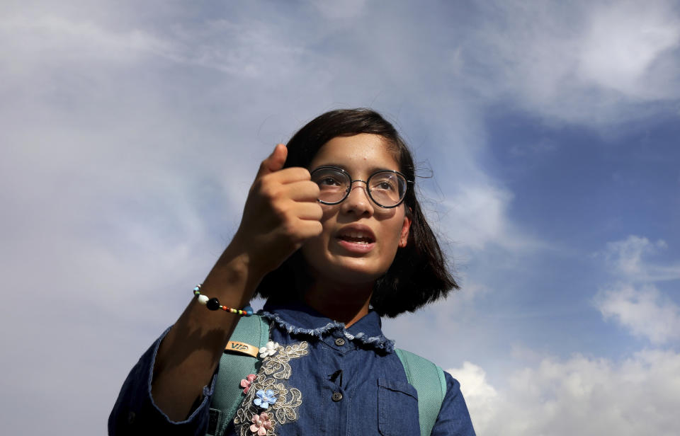 Indian child climate activist Ridhima Pandey, 11, gestures as she speaks upon her arrival from New York at the Indira Gandhi International airport, in New Delhi, India, Thursday, Sept. 26, 2019. Ridhima returned from her trip to the United Nations General Assembly, where she helped file a lawsuit, with children from around the world, against five countries for not tackling climate change. Pandey, from the northern state of Uttarakhand, previously sued the Indian government in 2017 for its inaction on the climate. (AP Photo/Manish Swarup)