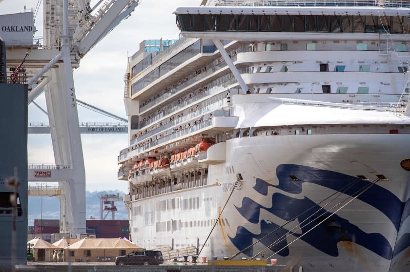 Medical personnel tend to passengers as they disembark from the Grand Princess cruise ship at the Port of Oakland in California on March 09, 2020. - The cruise ship carrying thousands of people who were stranded for days due to a coronavirus outbreak docked at the port of Oakland, near San Francisco, on Monday. Authorities said it would take two or three days to get the 2,421 passengers off the ship that had been idling for days off the coast of California. (Photo by Josh Edelson / AFP) (Photo by JOSH EDELSON/AFP via Getty Images)