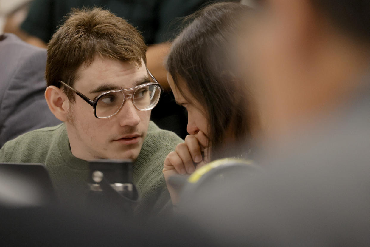 Marjory Stoneman Douglas High School shooter Nikolas Cruz speaks with sentence mitigation specialist Kate O'Shea, a member of the defense team, during the penalty phase of his trial at the Broward County Courthouse in Fort Lauderdale, Fla., Wednesday, Aug. 3, 2022. Cruz previously plead guilty to all 17 counts of premeditated murder and 17 counts of attempted murder in the 2018 shootings. (Amy Beth Bennett/South Florida Sun Sentinel via AP, Pool)