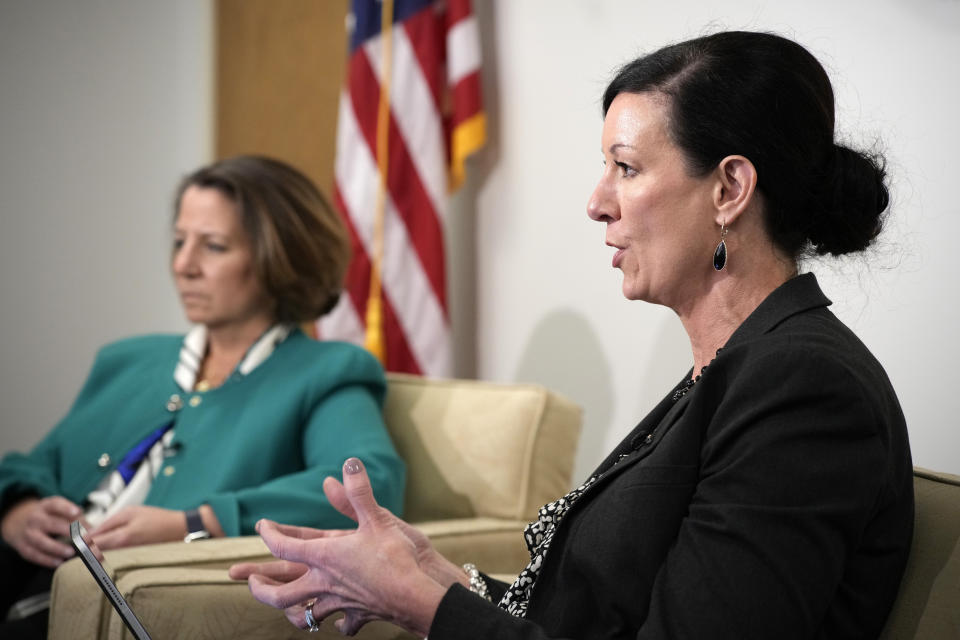 Colette Peters, front, director of the federal Bureau of Prisons, makes a point as Deputy Attorney General Lisa Monaco listens during an interview with The Associated Press Tuesday, April 25, 2023, in Aurora, Colo. Fundamental change in the Bureau of Prisons culture is part of a new mission statement announced Tuesday by Peters, who was hired last year after her predecessor resigned amid mounting pressure from Congress. (AP Photo/David Zalubowski)