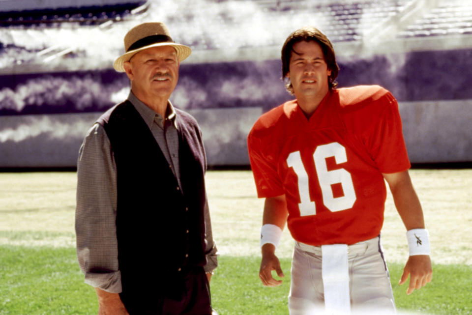 Gene standing with Keanu, who's wearing a football uniform