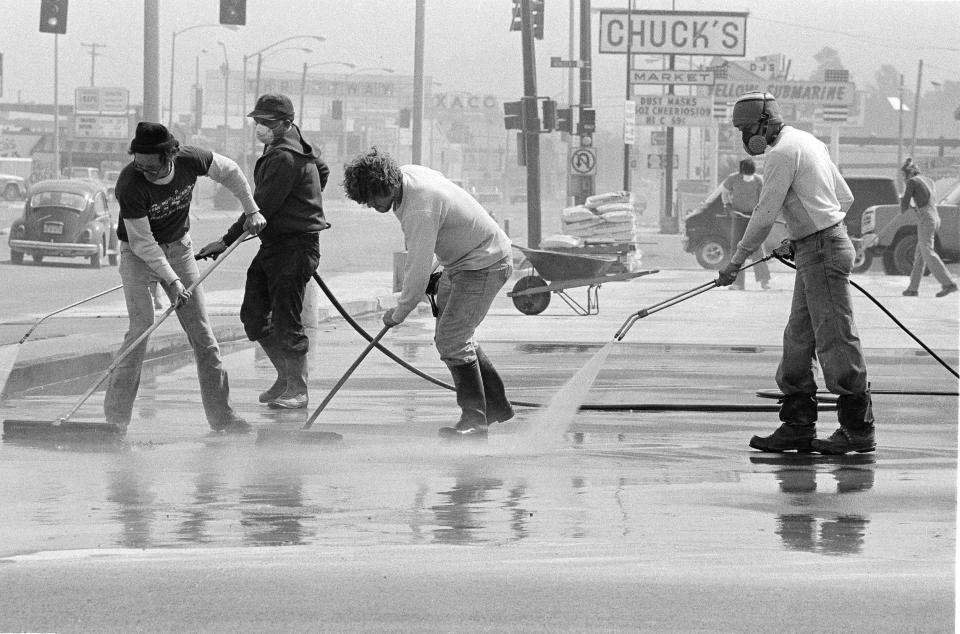 Residents of Longview, Wash., continue clean-up operations as the city tried to get back to normal despite deposits of ash from Mount St. Helens, June 2, 1980. The volcano continues to spew small amounts of ash and steam. 