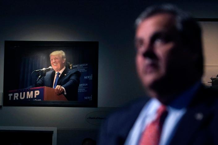 A photograph of former President Donald Trump hangs on the wall as Republican presidential candidate, former New Jersey Gov. Chris Christie listens to a question during a gathering, Tuesday, June 6, 2023, in Manchester, N.H. Christie filed paperwork Tuesday formally launching his bid for the Republican nomination for president after casting himself as the only candidate willing to directly take on Trump. (AP Photo/Charles Krupa) ORG XMIT: PNA211