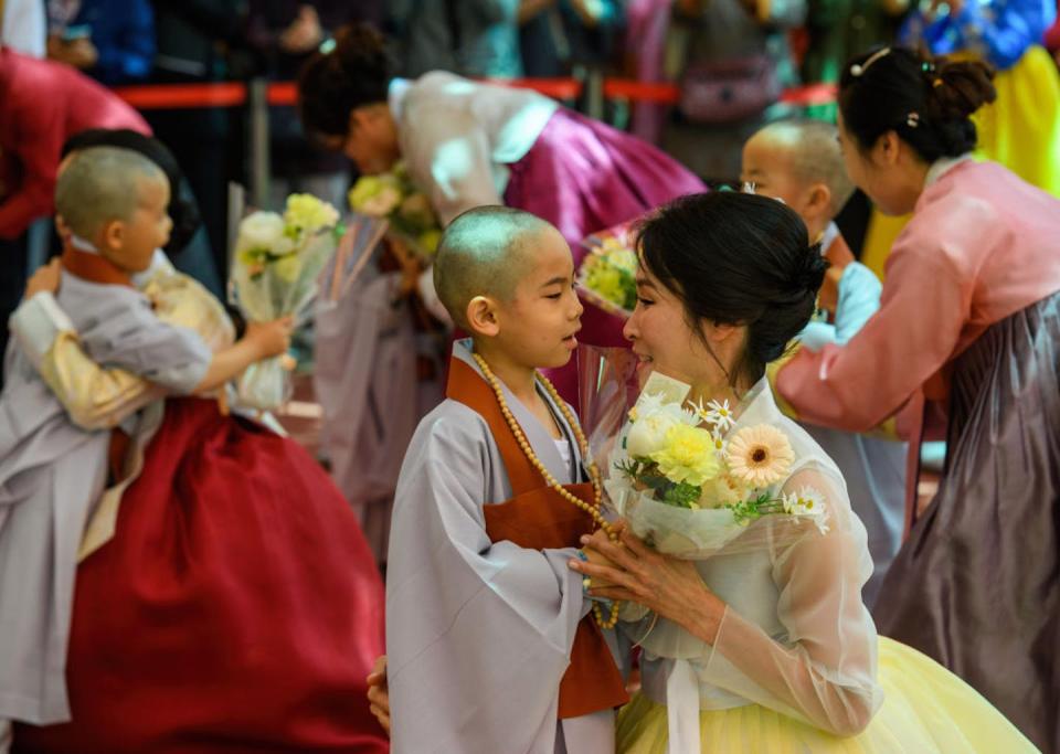 A South Korean child with his mother during celebrations for the Buddha’s birthday, when children are invited to become monks for three weeks. <a href="https://www.gettyimages.com/detail/news-photo/south-korean-child-monk-seen-with-his-mother-during-an-news-photo/1253452054?adppopup=true" rel="nofollow noopener" target="_blank" data-ylk="slk:Kim Jae-Hwan/SOPA Images/LightRocket via Getty Images;elm:context_link;itc:0;sec:content-canvas" class="link ">Kim Jae-Hwan/SOPA Images/LightRocket via Getty Images</a>