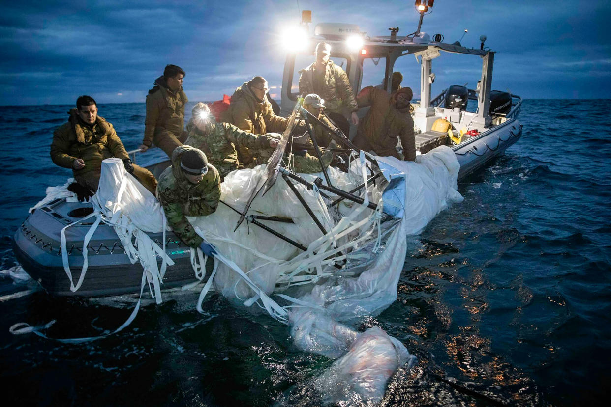 This image provided by the U.S. Navy shows sailors assigned to Explosive Ordnance Disposal Group 2 recovering a high-altitude surveillance balloon off the coast of Myrtle Beach, S.C., on Feb. 5, 2023.