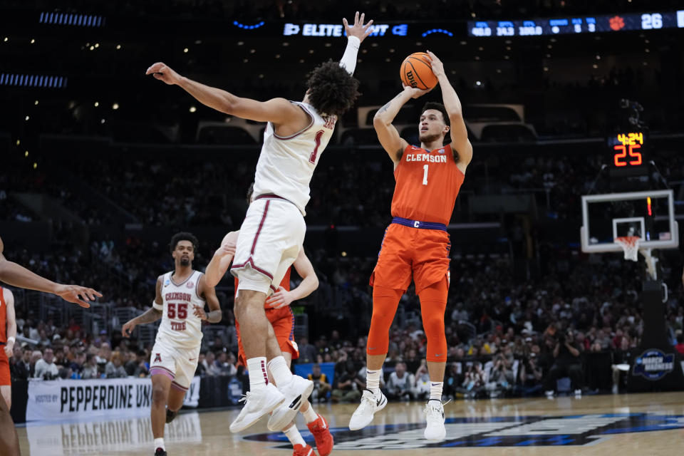 Clemson guard Chase Hunter (1) shoots over Alabama guard Mark Sears during the first half of an Elite 8 college basketball game in the NCAA tournament Saturday, March 30, 2024, in Los Angeles. (AP Photo/Ashley Landis)