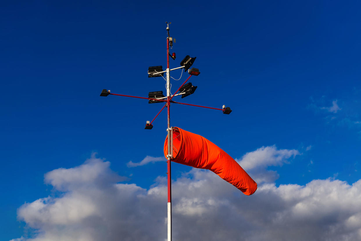 Orange windsock on signal post Getty Images/Sunphol Sorakul