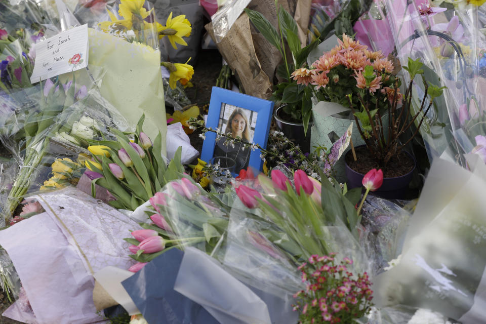 <p>A photograph of Sarah Everard amongst floral tributes and candles placed at the bandstand on Clapham Common, London, Monday March 15, 2021. On Saturday hundreds of people disregarded a judge's ruling and police requests by gathering at Clapham Common in honor of Sarah Everard. Everard disappeared while walking home from a friend's apartment and was found dead a week later. The slaying sent shockwaves across the U.K. because a Metropolitan Police officer is charged with her kidnapping and murder. (AP Photo/Kirsty Wigglesworth)</p>
