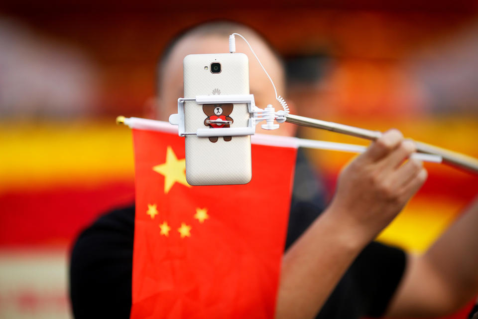 <p>A man takes pictures of himself as people gather in Tiananmen Square to celebrate National Day marking the 67th anniversary of the founding of the People’s Republic of China, in Beijing October 1, 2016. (REUTERS/Damir Sagolj) </p>