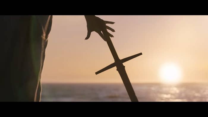 Gorr reaching for a sword in front of the sun in "Thor: Love and Thunder"