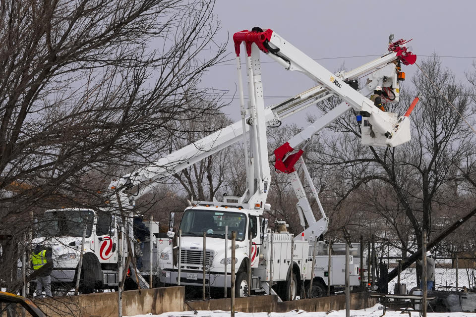 Utility workers from Xcel Energy labor on power lines near a home destroyed by the Smokehouse Creek Fire, Thursday, Feb. 29, 2024, in Stinnett, Texas. The utility provider Xcel Energy said Thursday, March 7, 2024 that its facilities appeared have played a role in igniting a massive wildfire in the Texas Panhandle that grew to the largest blaze in state history. (AP Photo/Julio Cortez)