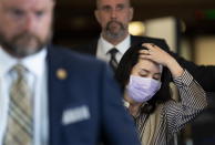 Meng Wanzhou is surrounded by security as she leaves B.C. Supreme Court in Vancouver, British Columbia, Monday, Sept. 28, 2020. The senior executive for Chinese communications giant Huawei Technologies was in court arguing that her extradition to the U.S. should be halted because her rights have been violated. (Jonathan Hayward/The Canadian Press via AP)