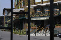 A general view through the main gates to Wimbledon as it is announced the the Wimbledon tennis Championships for 2020 has been cancelled due to the coronavirus in London, Wednesday, April 1, 2020. The new coronavirus causes mild or moderate symptoms for most people, but for some, especially older adults and people with existing health problems, it can cause more severe illness or death.(AP Photo/Kirsty Wigglesworth)