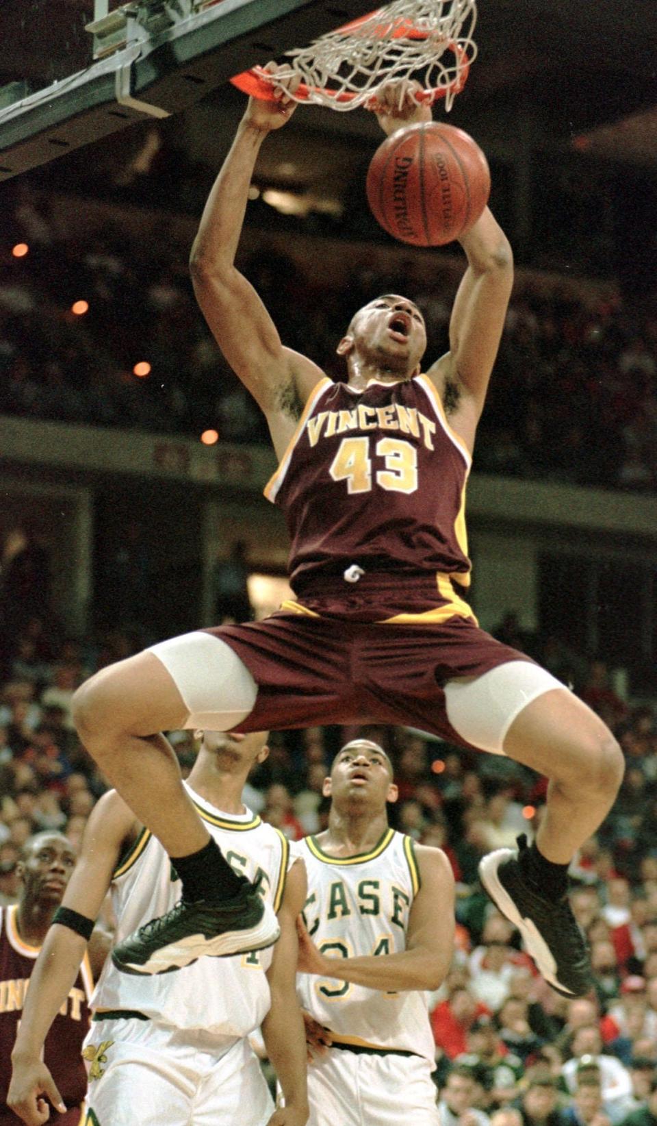 Milwaukee Vincent's James Wright (34) slams in front of Racine Case's Bryan Bedford (34) and Aziz Ward in the first half Friday, March 20, 1998, in their WIAA Div. 2 quarterfinal game.