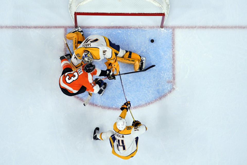 Philadelphia Flyers' Kevin Hayes (13) scores a goal past Nashville Predators goaltender Juuse Saros and the defense of Mattias Ekholm (14) during the second period an NHL hockey game, Saturday, Feb. 11, 2023, in Philadelphia. (AP Photo/Derik Hamilton)