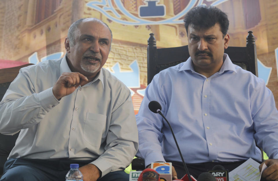 Secretary General Maqsood Bijrani, left, and Captain Chaudhry Salman, President of Pakistan Airlines Pilots' Association address a news conference in Karachi, Pakistan, Saturday, June 27, 2020. A union of Pakistani pilots on Saturday fired back at the country's aviation minister, who claims as many as 262 pilots serving at state-run Pakistan International airlines and other airline companies, obtained licenses to fly planes by having others take exams for them.(AP Photo/Fareed Khan)