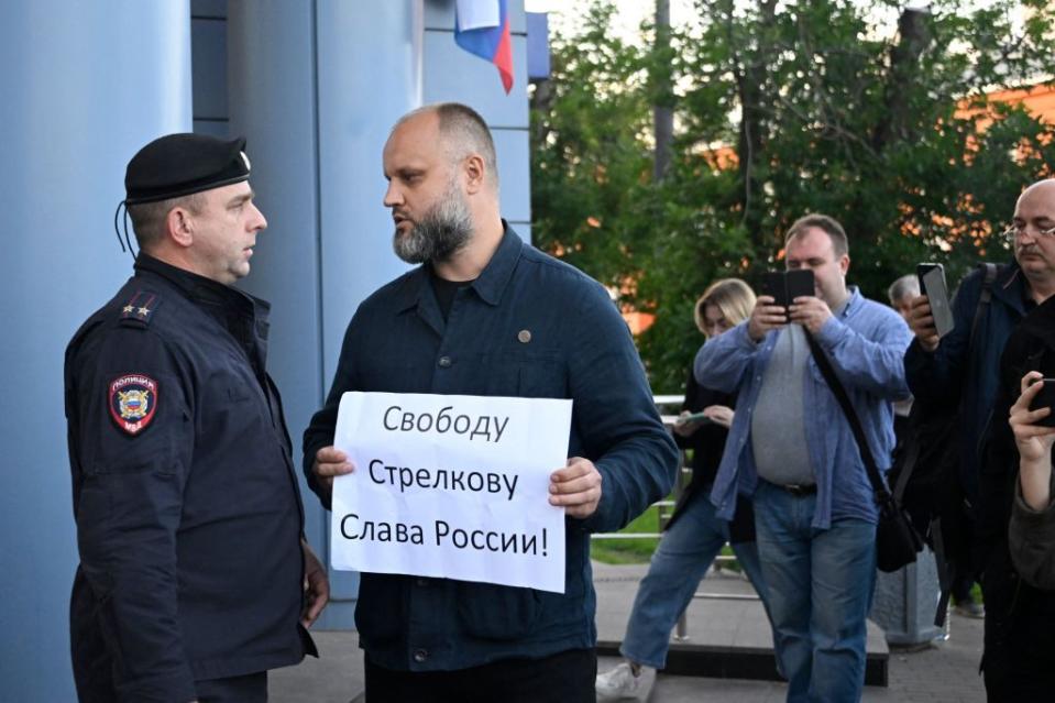 Russian proxy Pavel Gubarev pickets outside the Moscow City Court with a placard reading "Freedom to Strelkov. Glory to Russia!" during a pre-trial hearing on the arrest of Igor "Strelkov" Girkin, a Russian war criminal, milblogger, and the former commander of Russia's proxies in occupied Donetsk Oblast, detained on July 21 and accused of extremism, in Moscow, Russia. (Photo by ALEXANDER NEMENOV/AFP via Getty Images)