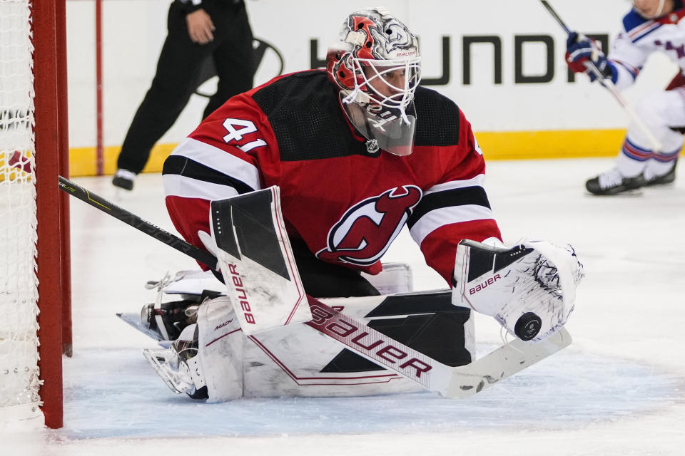 New Jersey Devils goaltender Vitek Vanecek (41) stops a shot by the New York Rangers during the first period of an NHL preseason hockey game Wednesday, Oct. 4, 2023, in Newark, N.J. (AP Photo/Frank Franklin II)