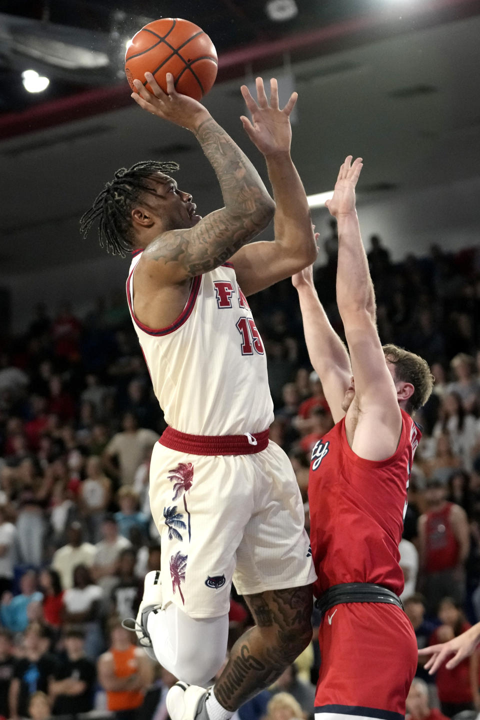 Florida Atlantic guard Alijah Martin (15) goes to the basket as Liberty guard Kaden Metheny, right, defends during the first half of an NCAA college basketball game, Thursday, Nov. 30, 2023, in Boca Raton, Fla. (AP Photo/Lynne Sladky)