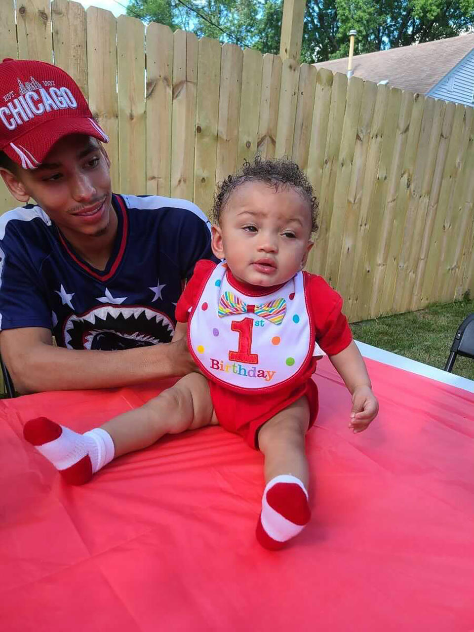 This photo provided by Ben Crump Law, PLLC. shows Daunte Wright and his son Daunte Jr., at his first birthday party. A white police officer who fatally shot Daunte Wright during a traffic stop in a Minneapolis suburb resigned Tuesday, April 13, 2021 as did the city's police chief — moves that the mayor said he hoped would help heal the community and lead to reconciliation after two nights of protests and unrest. (Ben Crump Law, PLLC. via AP)