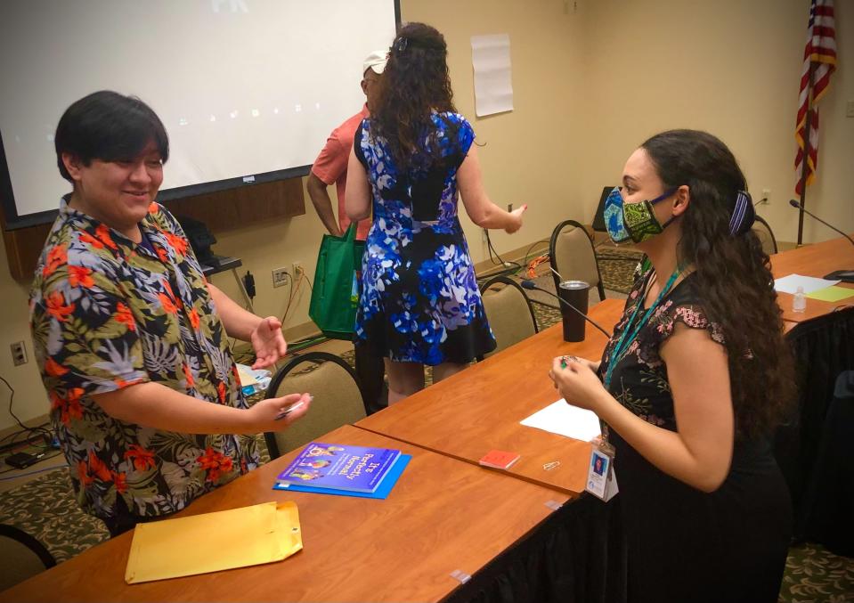 Santiago Duarte, a 16-year-old Winter Haven High School junior, speaks to fellow book review panel member Nicole Grassel-Torres, an English teacher at Haines City High School, following Tuesday night's meeting.