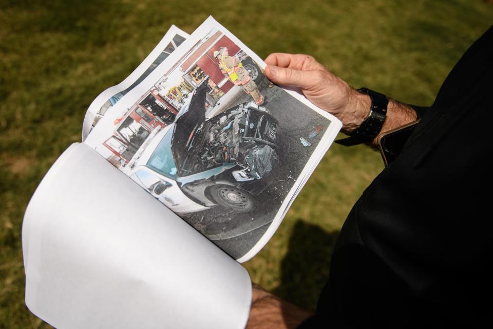 Charles McLoughlin, 72, looks at a photo of the Syracuse Police cruiser that crashed into him over 10 years ago, a collision that caused a life-altering neck injury and cost him his job as a medical transport driver.