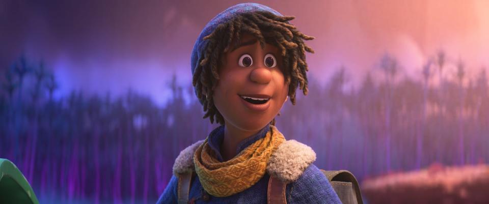 a young, biracial Black teenager in the animated film "Strange World." he has hair coming out from underneath a beanie, and wears small, golden hoop earrings. there's an earnest, eager expression on his face